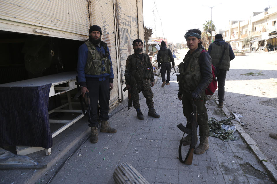 Turkish backed Syrian rebels enter the own of Saraqeb, in Idlib province, Syria, Thursday, Feb. 27, 2020. Turkey-backed Syrian opposition fighters Thursday retook a strategic northwestern town iof Saraqeb, opposition activists said, and cut off the key highway linking the capital, Damascus, with the northern city of Aleppo, days after the government reopened it for the first time since 2012. (AP Photo/Ghaith Alsayed)