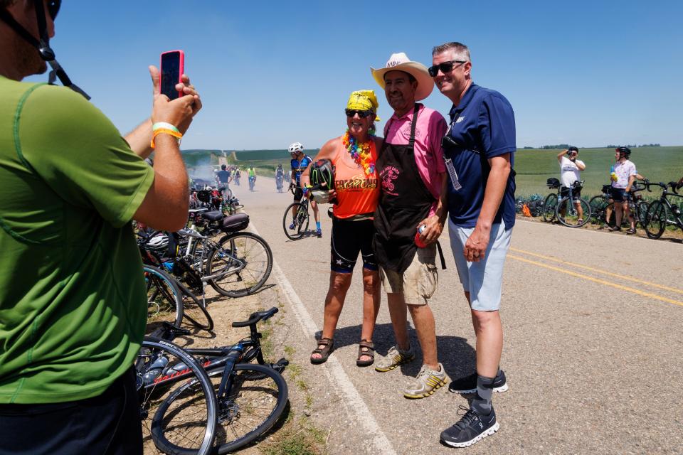 Mr. Pork Chop Matt Bernhard, center, poses for a photo with Ride director Matt Phippen, right, on RAGBRAI day 1 on Sunday, July 24, 2022.