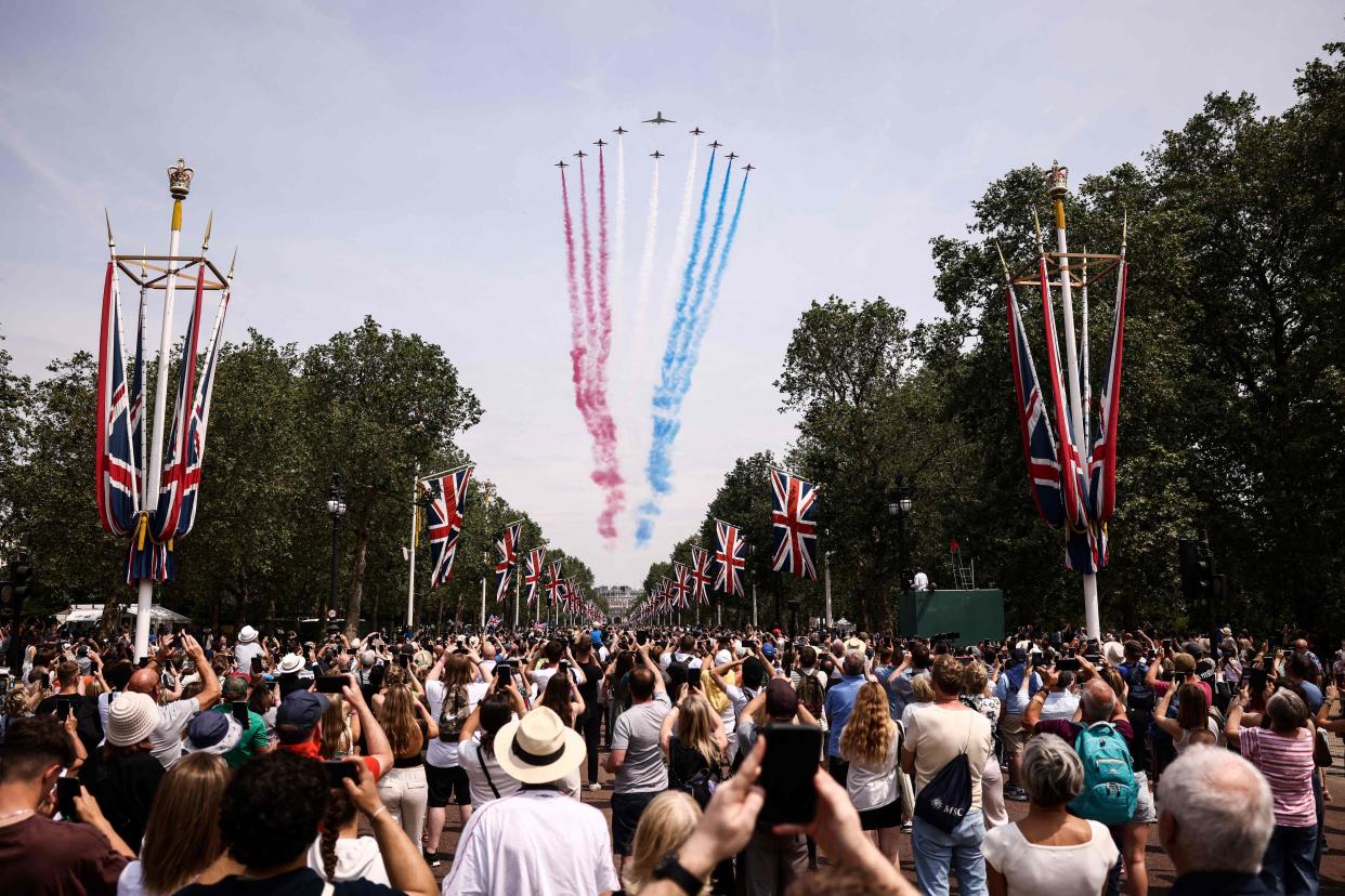 Members of the public cheer as they watch the Royal Air Force Aerobatic Team, the Red Arrows during the King's Birthday Parade (AFP via Getty Images)