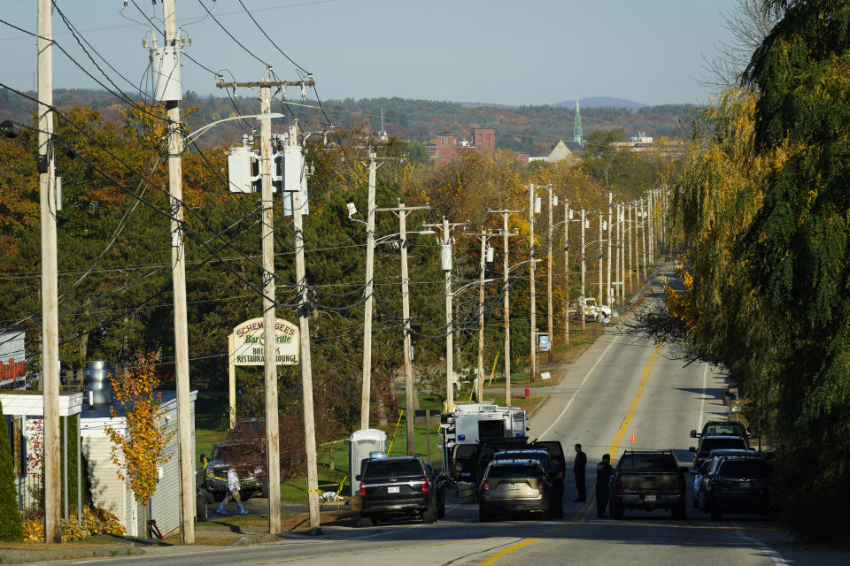 Law enforcement officers maintain their presence at Schemengees Bar and Grille in the aftermath of a mass shooting in Lewiston, Maine, Saturday, Oct. 28, 2023. The suspect, Robert Card, a firearms instructor who grew up in the area, was found dead in nearby Lisbon Falls, Gov. Janet Mills said at a Friday night news conference. (AP Photo/Matt Rourke)