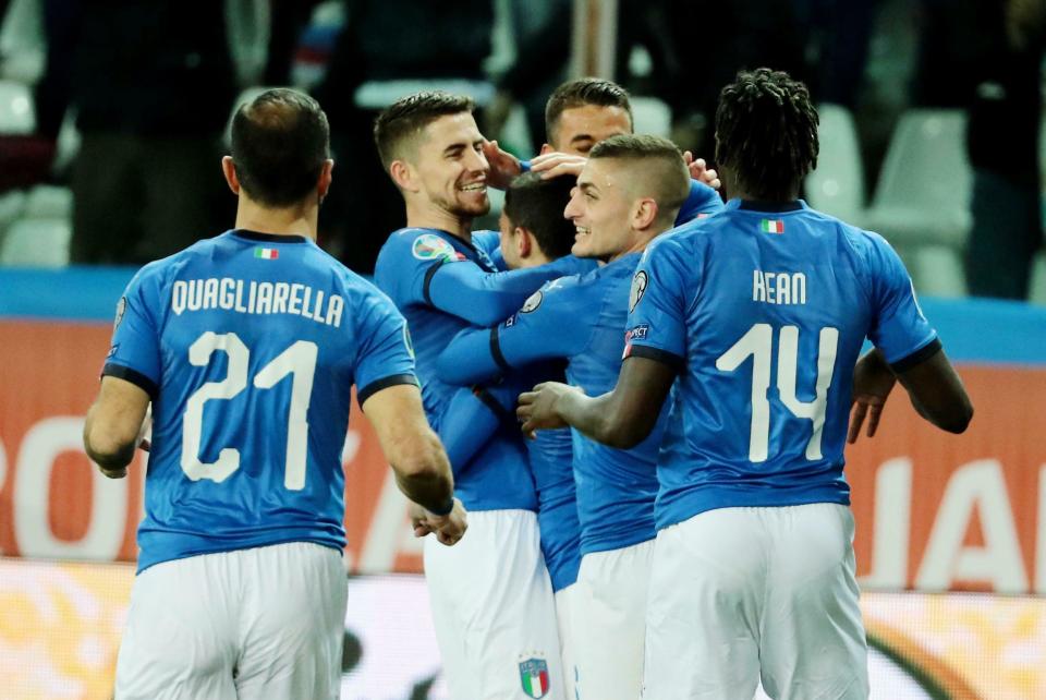 Italy's Stefano Sensi, , partially covered, back to camera, celebrates with his teammates after scoring his team's first goal during a Euro 2020 Group J qualifying soccer match between Italy and Liechtenstein, at the Ennio Tardini stadium in Parma, Italy, Tuesday, March 26, 2019. (Serena Campanini/ANSA via AP)