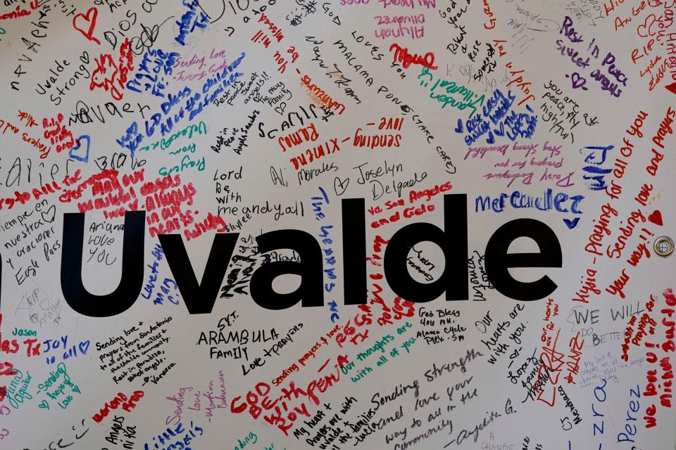 Messages are seen on a sign left at a memorial outside Robb Elementary School created to honor the victims killed in the recent school shooting, Friday, June 3, 2022, in Uvalde, Texas. Two teachers and 19 students were killed.