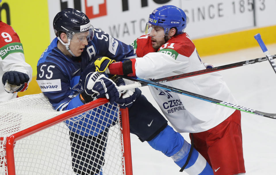 Czech Republic's Lukas Klok, right, pushes Finland's Atte Ohtamaa during the Ice Hockey World Championship quarterfinal match between Finland and Czech Republic at the Arena in Riga, Latvia, Thursday, June 3, 2021. (AP Photo/Sergei Grits)
