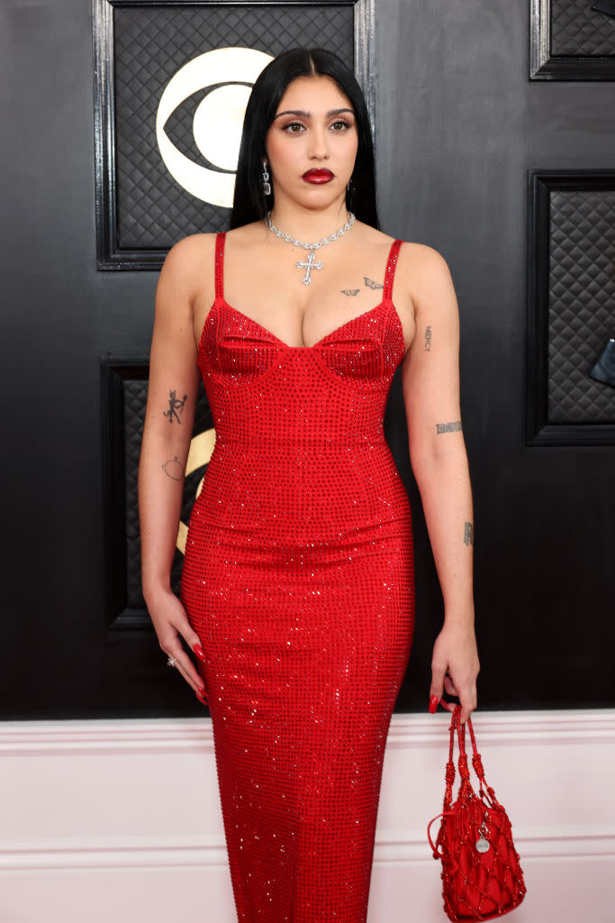 Lourdes Leon in crimson gown with Madonna bodice and matching bag.