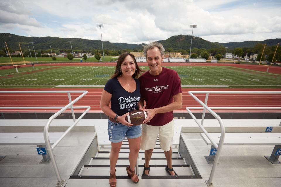 Former Dickinson State vice president Carmen Wilson and her husband, former UW-La Crosse Chancellor Joe Gow, pose for a photo when the football teams of their respective schools played in 2018. Gow was fired Wednesday for making porn videos with his wife.