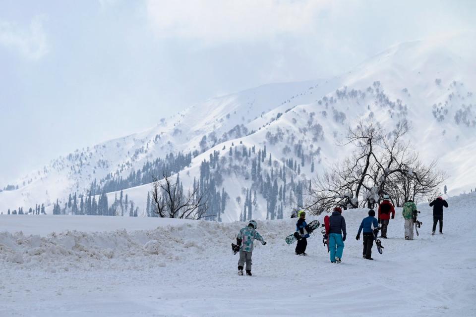 Participants walk during the opening ceremony of Khelo India Winter Games at a ski resort in Gulmarg north of Srinagar on February 10, 2023 (AFP via Getty Images)