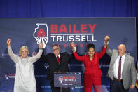 Republican gubernatorial candidate Illinois state Sen. Darren Bailey, center, celebrates with his wife Cindy Stortzum, left, and Lt. Gov. candidate Stephanie Trussell and her husband William after winning the Republican primary Tuesday, June 28, 2022, in Effingham, Ill. Bailey will now face Democratic Gov. J.B. Pritzker in the fall. (AP Photo/Charles Rex Arbogast)