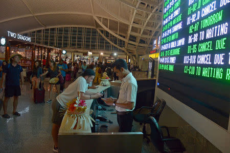 Passengers are seen waiting for flight information following the eruption of Mount Agung volcano at Ngurah Rai Airport in Bali, Indonesia November 25, 2017 in this photo taken by Antara Foto. Antara Foto/Wira Suryantala via REUTERS