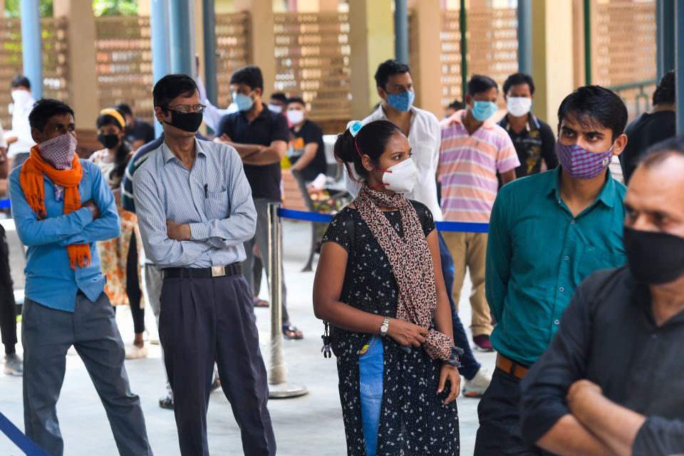 People wait in a queue for Rapid Antigen Test (RAT) for the coronavirus at an ayurvedic dispensary in a residential area in New Delhi on September 7, 2020. (Photo by PRAKASH SINGH/AFP via Getty Images)