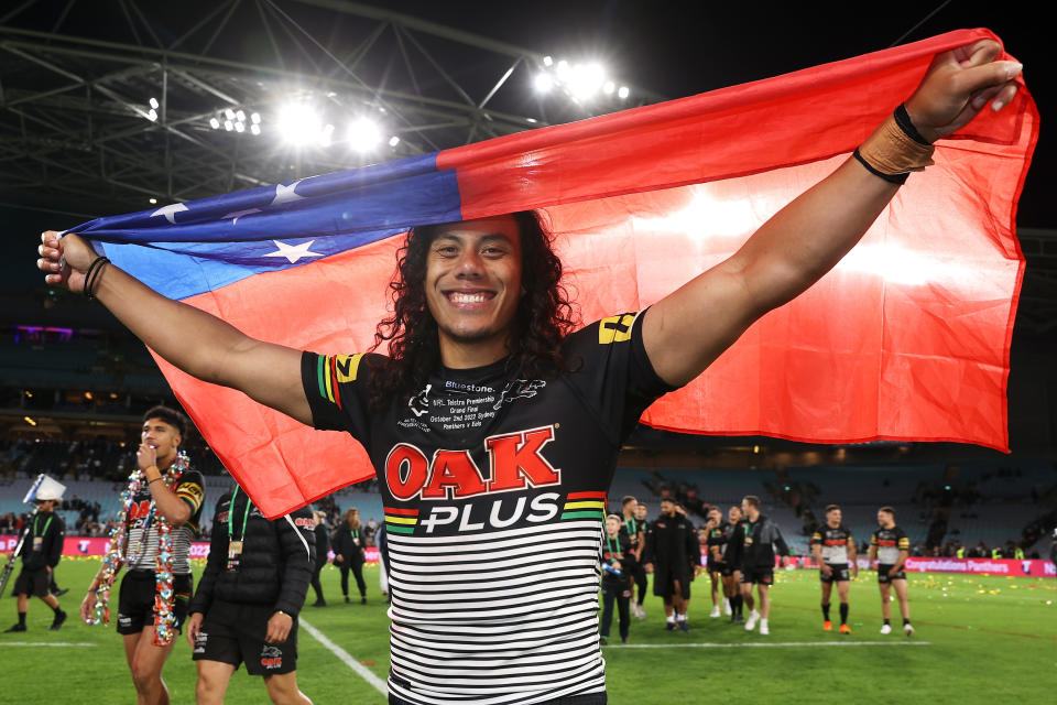 Seen here, Jarome Luai celebrates with the Samoa flag after Penrith's victory in the 2022 NRL grand final.