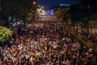 Pro-democracy activists march close to Government House, the prime minister's offices during a protest march in Bangkok, Thailand, Wednesday, Oct. 21, 2020. Thailand's prime minister on Wednesday pleaded with his countrymen to resolve their political differences through Parliament, as student-led protests seeking to bring his government down continued for an eighth straight day. (AP Photo/Sakchai Lalit)