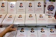 FILE PHOTO: Copies of the book "Xi Jinping: The Governance of China" are displayed at the Hong Kong Book Fair, in Hong Kong