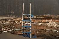 The remains of a slide are seen in the yard of a home destroyed by fire in the Cascade mountain range during the aftermath of the Riverside Fire near Molalla, Oregon