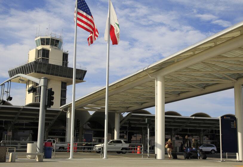 FILE - Travelers prepare to enter Oakland International airport Tuesday, Nov. 26, 2013, in Oakland, Calif.