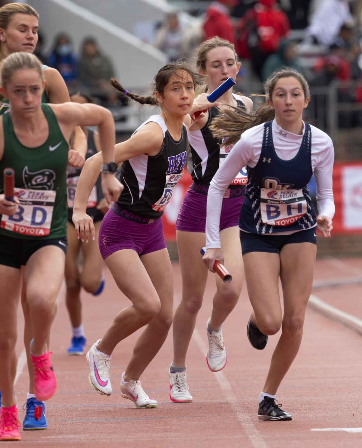 Rumson's Reese Malone takes handoff from teammate Hannah Nitka in Rumson's second place effort. Rumson-Fair Haven Girls in the Girls 4X800 at Penn Relays on Friday, April 25, 2024.