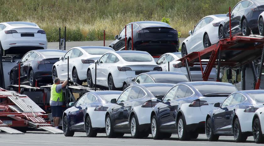 FILE - In this May 13, 2020, file photo, Tesla cars are loaded onto carriers at the Tesla electric car plant in Fremont, Calif. California Gov. Gavin Newsom said Wednesday, Sept. 23 that the state will halt sales of new gasoline-powered passenger cars and trucks by 2035. He ordered state regulators to come up with requirements to meet that goal. California would be the first state with such a rule, though Germany and France are among 15 other countries that have a similar requirement. (AP Photo/Ben Margot, File)