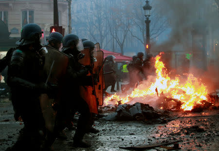 Policemen advance during a "Yellow vest" protest against higher fuel prices during clashes on the Champs-Elysees in Paris, France, November 24, 2018. REUTERS/Gonzalo Fuentes