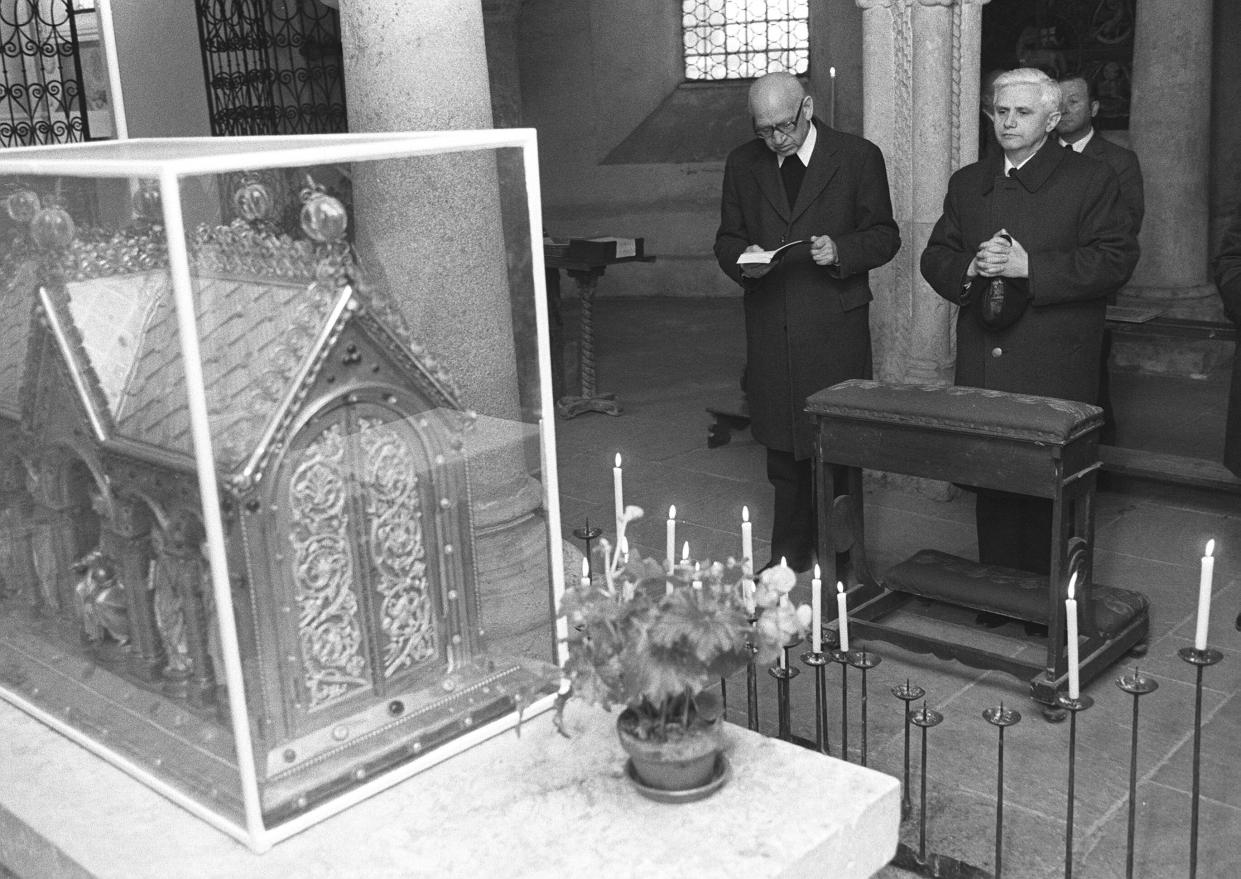 FILE - Newly nominated Archbishop of Munich and Freising, Joseph Ratzinger, right, prays with Bishop Erns Tewes in the Crypta of the Cathedral of Freising, southern Germany, on March 31, 1977. Ratzinger went on to become Pope Benedict XVI. Pope Emeritus Benedict XVI, the German theologian who will be remembered as the first pope in 600 years to resign, has died, the Vatican announced Saturday. He was 95. (AP Photo/Dieter Endlicher, File)