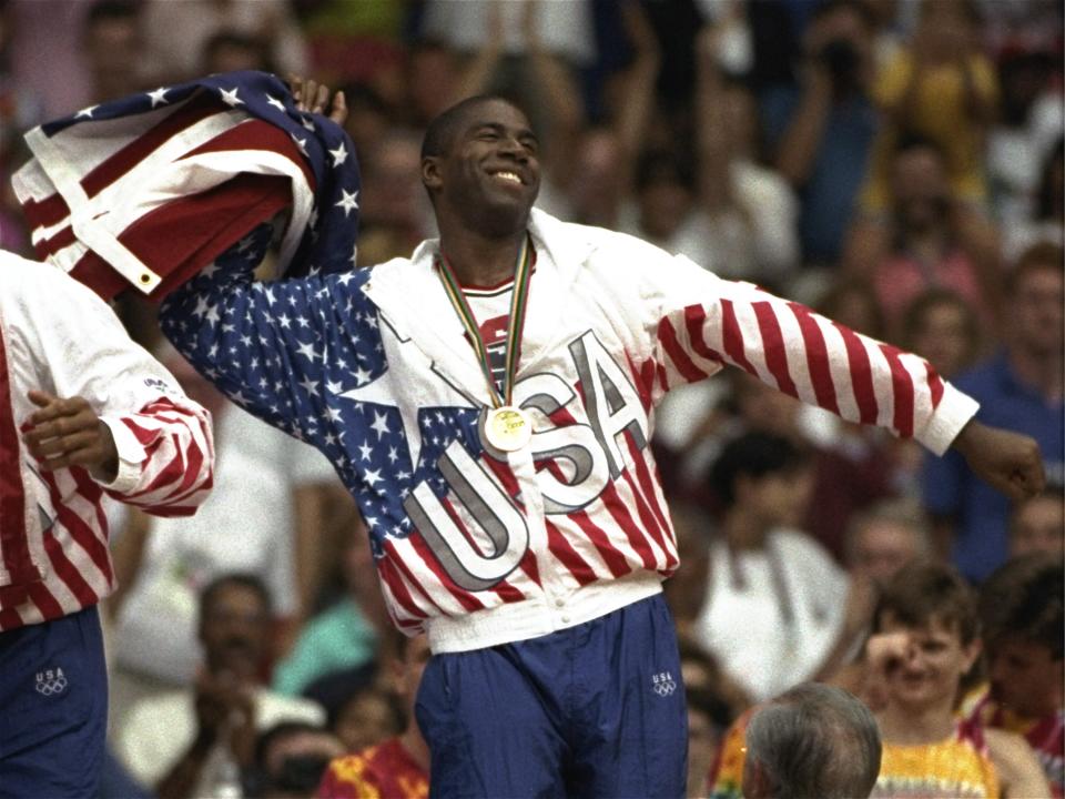 USA's Earvin "Magic" Johnson whips the United States flag in ecstasy during the gold medal ceremony Saturday, August 8, 1992,  during the 1992 Summer Olympic games in Barcelona. (AP Photo/ Susan Ragan)