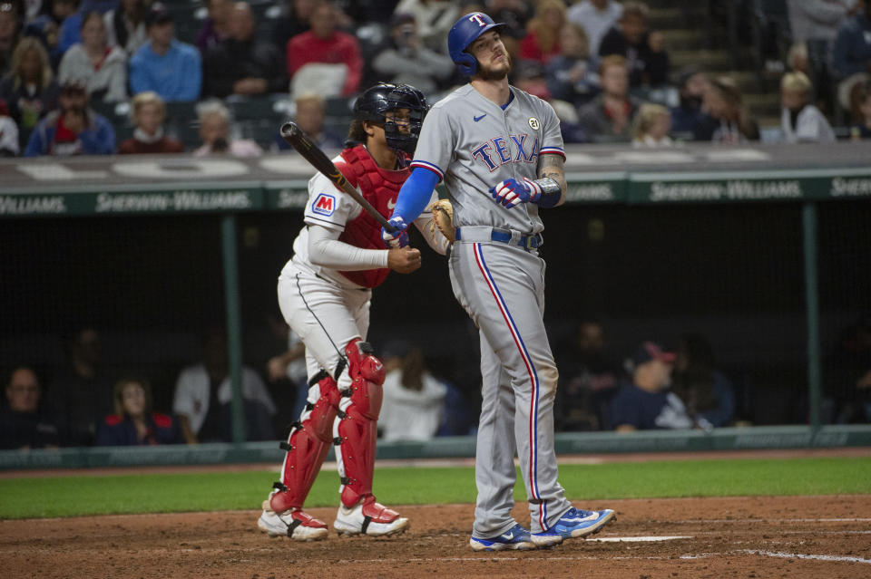 Texas Rangers' Jonah Heim reacts after striking out, next to Cleveland Guardians catcher Bo Naylor during the fifth inning of a baseball game in Cleveland on Friday, Sept. 15, 2023. (AP Photo/Phil Long)