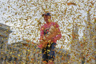 Britain's Tao Geoghegan Hart holds the trophy after winning the Giro d'Italia cycling race, in Milan, Italy, Sunday, Oct. 25, 2020. In one of the most exciting final stages of a Grand Tour, British rider Tao Geoghegan Hart won the Giro d’Italia on Sunday, edging out Australian Jai Hindley by just 39 seconds. (AP Photo/Luca Bruno)