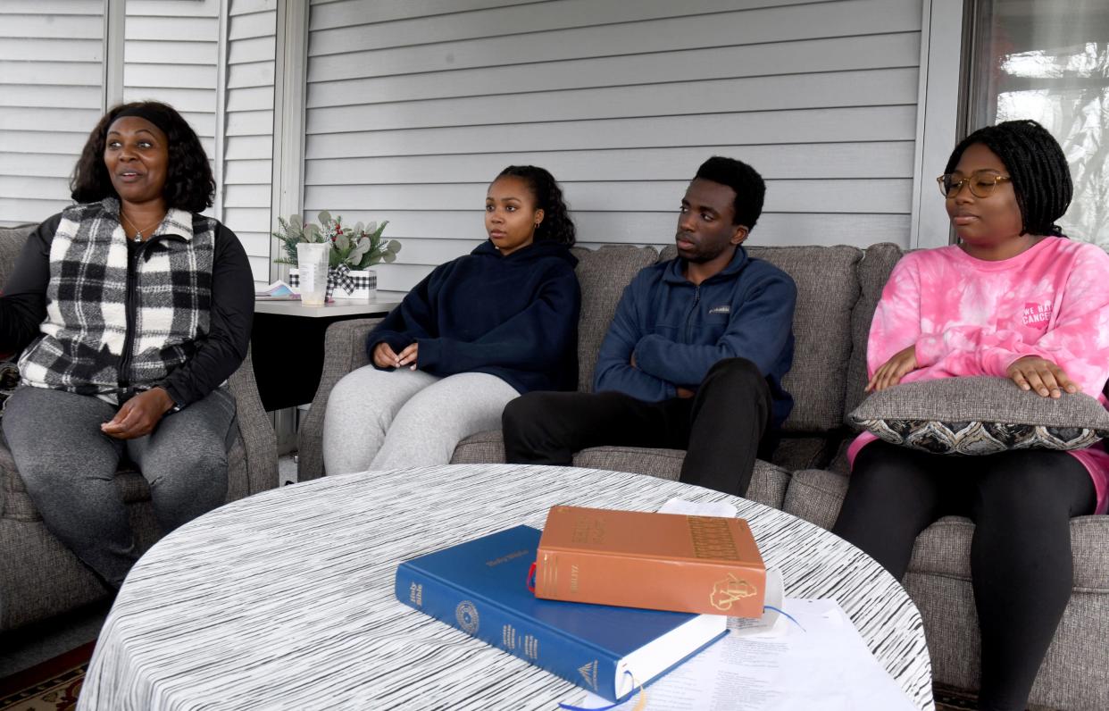 Chantal Nshimiye with children, from left to right, Tiffany, Nestor and Destiny Nshimiye, at their Stark County home. The family's patriarch, Eric Nshimiye, was arrested last month, accused of raping and killing innocents in his homeland of Rwanda in 1994.