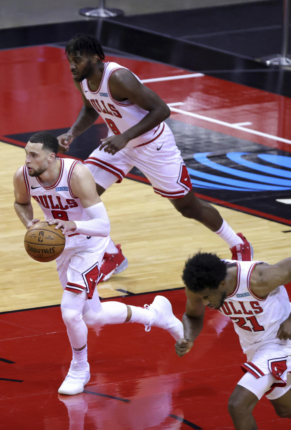 Chicago Bulls' Zach LaVine, left, heads upcourt with the ball during the third quarter of an NBA basketball game against the houston RocketsMonday, Feb. 22, 2021, in Houston. (Carmen Mandato/Pool Photo via AP)