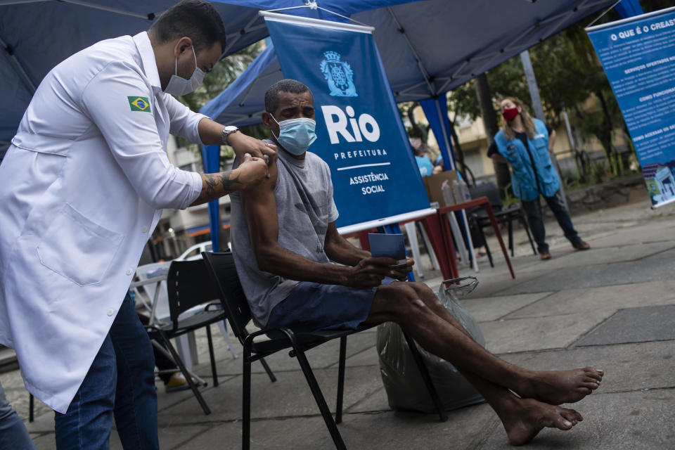 A man gets a shot of the AstraZeneca vaccine for COVID-19 during a vaccination program for the homeless at a public square in Rio de Janeiro, Brazil, Thursday, May 27, 2021. (AP Photo/Bruna Prado)