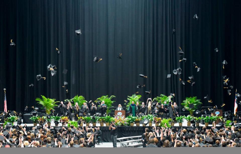 Providence High School graduates throw their mortarboards into the air moments after officially graduating High School on Wednesday, June 14, 2023, at Bojangles Coliseum.