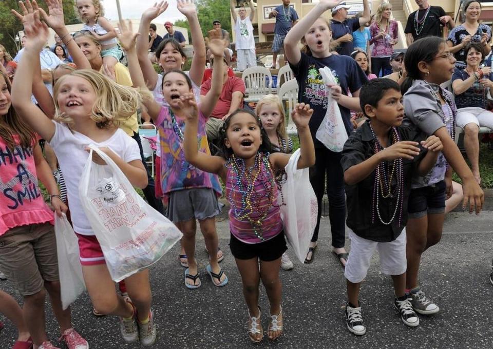 Children shout for beads during a past De Soto Grand Parade. HERALD FILE PHOTO/ttompkins@bradenton.com