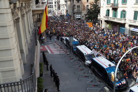 People walk past National Police main police station during a demonstration two days after the banned independence referendum in Barcelona, Spain, October 3, 2017. REUTERS/Yves Herman