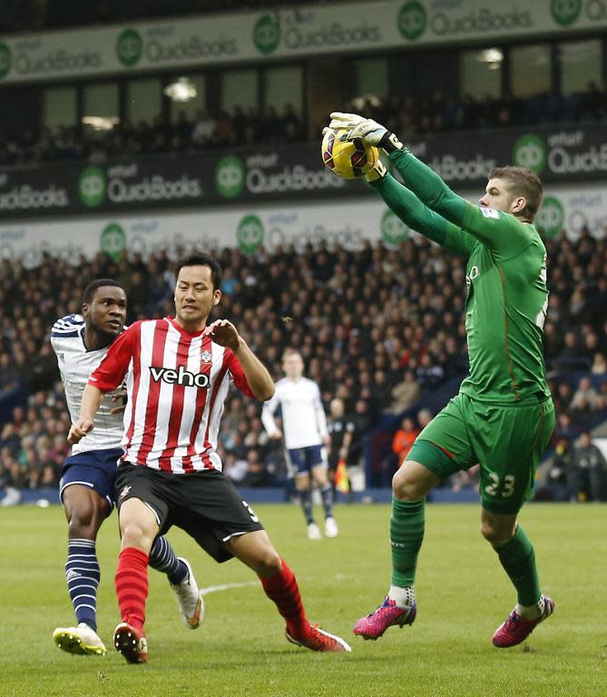 Southampton's English goalkeeper Fraser Forster (R) catches the ball during the English Premier League football match between West Bromwich Albion and Southampton in West Bromwich, England on February 28, 2015