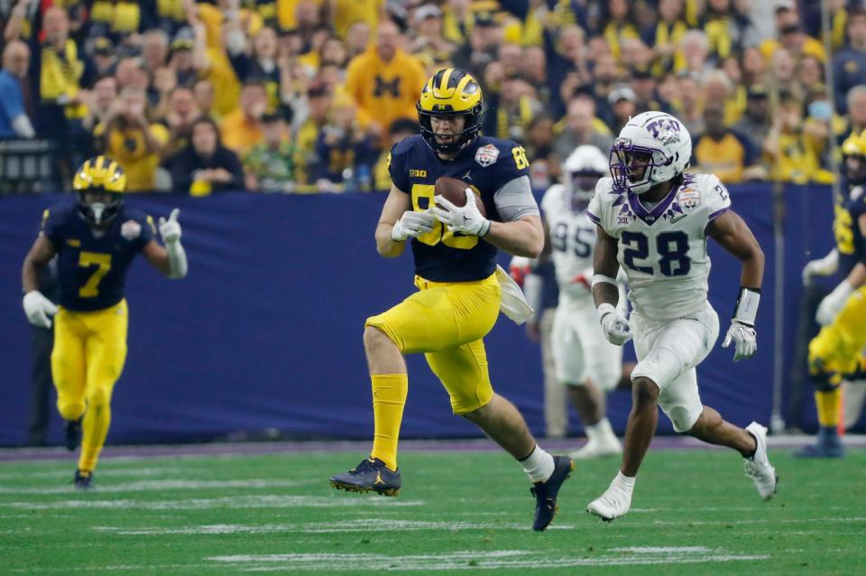 Michigan tight end Luke Schoonmaker (86) runs the ball around TCU safety Millard Bradford (28) in the first quarter of the Fiesta Bowl on Saturday, Dec. 31 at State Farm Stadium in Glendale, Ariz.