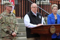 Maryland Gov. Larry Hogan, who chairs the National Governors Association, announces five priorities that governors are asking of the federal government to fight the coronavirus during a news conference Thursday, March 19, 2020 in Annapolis, Md. Maj. Gen. Timothy Gowen, the adjutant general of the Maryland National Guard is standing left. Karen Salmon, Maryland's superintendent of schools, is standing right. (AP Photo/Brian Witte)