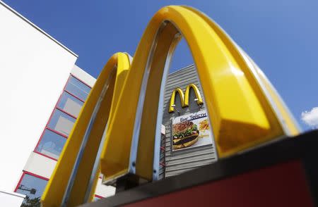 A logo of McDonald's Corp's is on display outside its restaurant on the outskirts of Moscow July 25, 2014. Russia's consumer protection agency has filed a lawsuit in a Moscow court seeking to ban some of McDonald's Corp's burgers along with its milk shakes and ice cream, a court spokeswoman said on July, 25, 2014. REUTERS/Maxim Shemetov