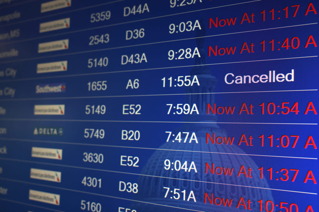 Flight delays are shown on a flight information board at Ronald Reagan Washington National Airport on Jan. 11, 2023