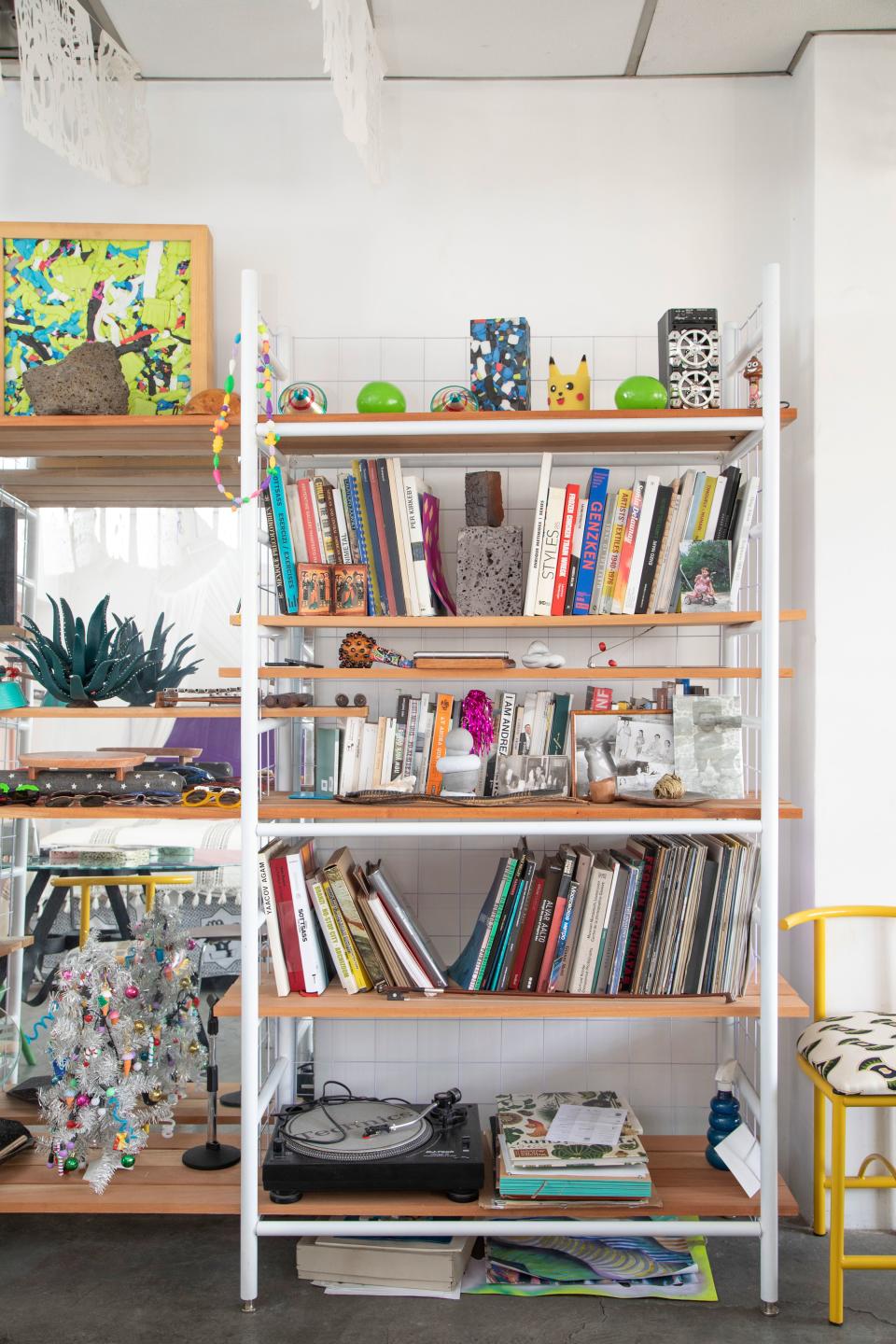 Bookshelves hold a hodgepodge of multicolored trinkets and treasures.