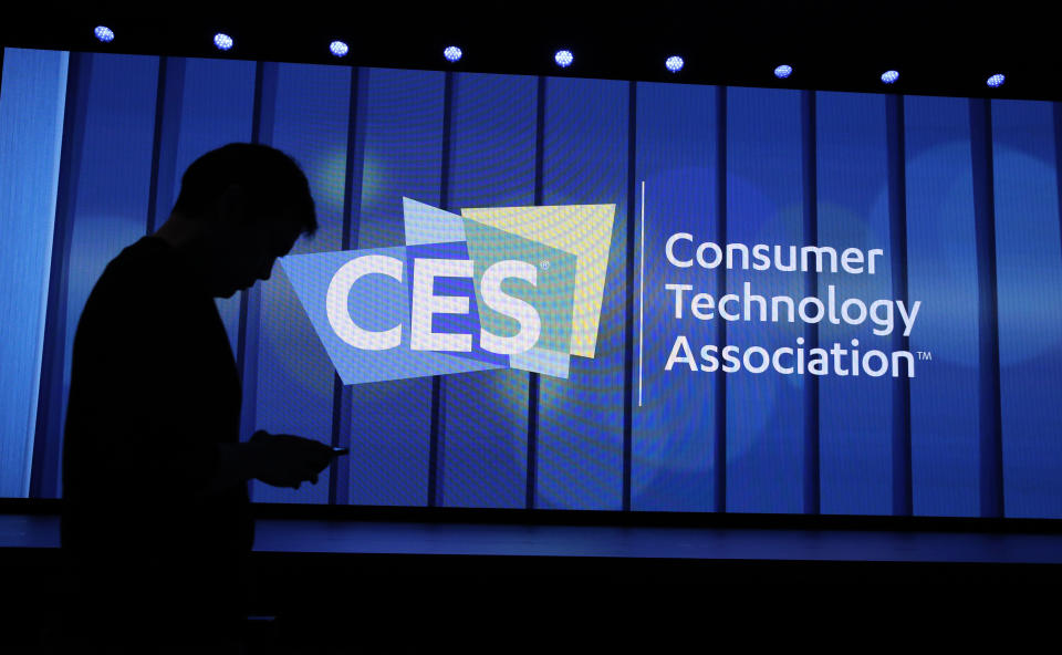 A person walks past a sign at a Samsung keynote before the CES tech show, Monday, Jan. 6, 2020, in Las Vegas. (AP Photo/John Locher)