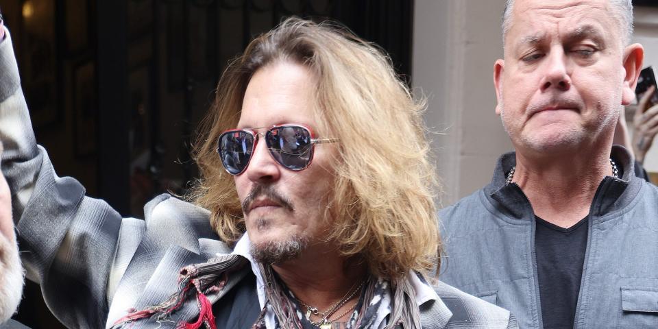 Johnny Depp leaving a hotel with a minder behind him on June 6, 2022 in Birmingham, England