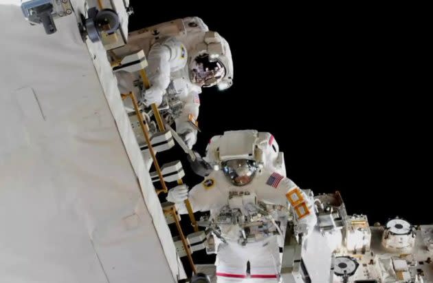 NASA astronauts Nick Hague and Anne McClain swap batteries during a spacewalk. (NASA Photo)