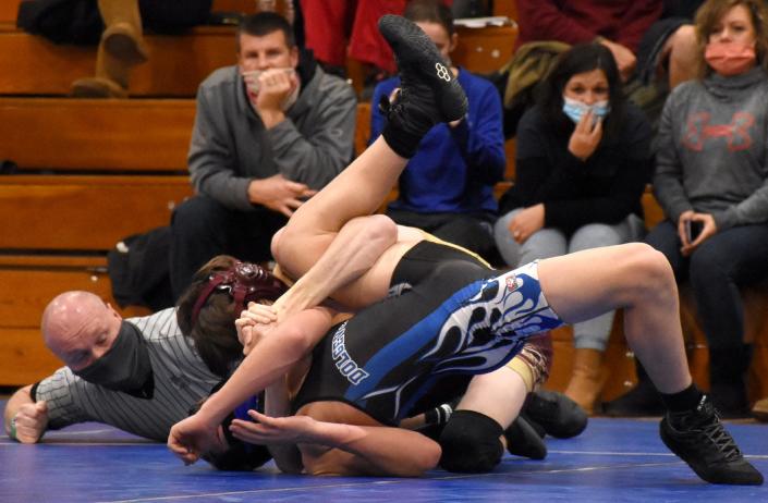 Canastota&#39;s Kyle Musachio tries to pin Dolgeville Blue Devil Bryce Mosher (foreground) during the first period of Tuesday&#39;s 126-pound bout in Dolgeville. Musachio, who earned his 100th varsity victory earlier this month, won a 7-4 decision.