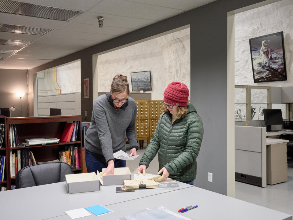 Stauffer (left) and Kubiak right, look through an archival box related to Otto Bettmann and his archive.