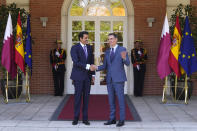 The Emir of Qatar Sheikh Tamim bin Hamad Al Thani, left, shakes hands with Spain's Prime Minister Pedro Sanchez at the Moncloa Palace in Madrid, Spain, Wednesday, May 18, 2022. The emir of Qatar said that his energy-rich gulf state is set to boost investments in Spain by 4.7 billion euros (4.9 billion) dollars in the coming years, Spanish media reported late on Tuesday. The details of the investments have not been made public but with Europe scrambling to find alternatives to Russian energy, Qatar is positioned to help fill the gap with exports of liquified natural gas. (AP Photo/Paul White)