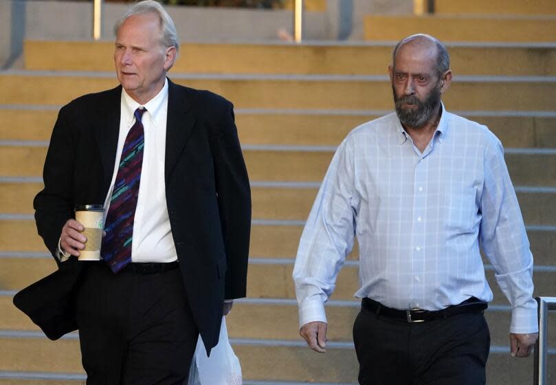 Defendant Jerry Boylan, right, captain of a scuba dive boat called the Conception, arrives in Federal court in Los Angeles, Tuesday, Oct. 24, 2023. Federal prosecutors are seeking justice for 34 people killed in a fire aboard the boat in 2019. The trial against Boylan began Tuesday, with jury selection. Boylan has pleaded not guilty to one count of misconduct or neglect of ship officer. (AP Photo/Damian Dovarganes)