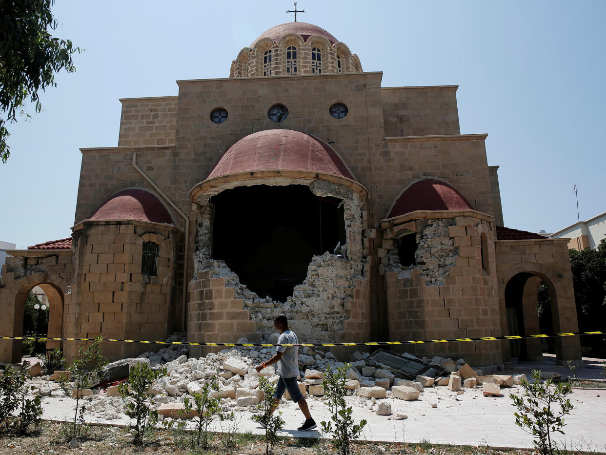 A man walks past a damaged church following an earthquake off the island of Kos: REUTERS