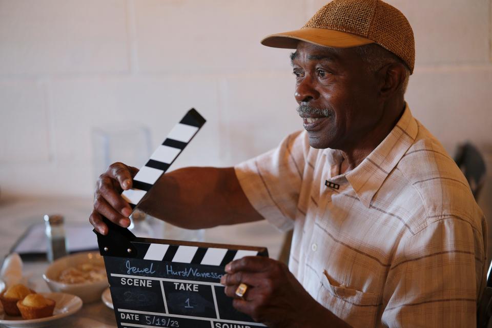 Arthur Hurst snaps the clapperboard to sync sound during filming on the upcoming documentary "The Jewel." The documentary delves into the history of Oklahoma City's historic Jewel Theatre, which Hurst owns.