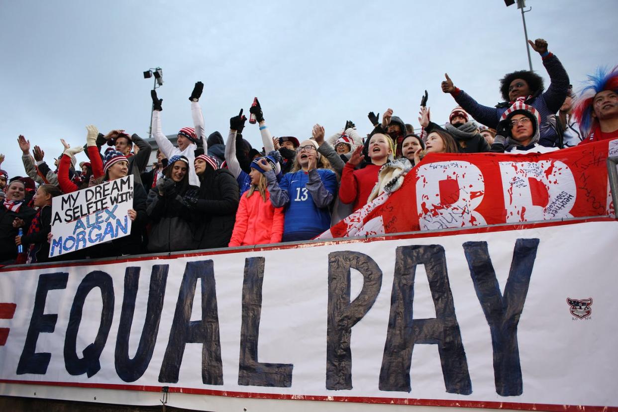 <span class="caption">Fans rally for the U.S. women's soccer team.</span> <span class="attribution"><a class="link " href="https://www.gettyimages.com/detail/news-photo/fans-with-an-equal-play-equal-pay-banner-supporting-the-news-photo/520040916?adppopup=true" rel="nofollow noopener" target="_blank" data-ylk="slk:Tim Clayton/Corbis via Getty Images;elm:context_link;itc:0;sec:content-canvas">Tim Clayton/Corbis via Getty Images</a></span>