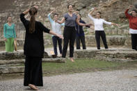 Greek actress Xanthi Georgiou, center, playing the role of the High Priestess, gestures during the final rehearsal for the lighting of the Olympic flame at Ancient Olympia site, birthplace of the ancient Olympics in southwestern Greece, Sunday, Oct. 17, 2021. The flame will be transported by torch relay to Beijing, China, which will host the Feb. 4-20, 2022 Winter Olympics. (AP Photo/Petros Giannakouris)