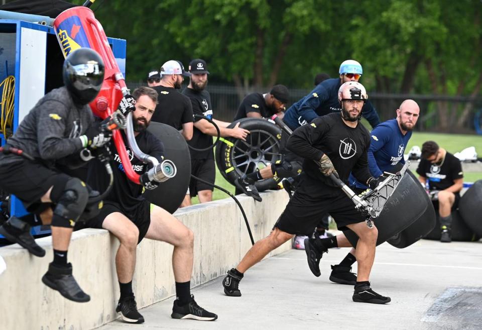 NASCAR driver Ross Chastain’s Trackhouse Racing pit crew members (L-R) Ken Pozega, Brook Davenport, Shane Wilson, Matt Simmons, and Michael Roberts prepare to rush around the car during pit practice on Tuesday, June 11, 2024.