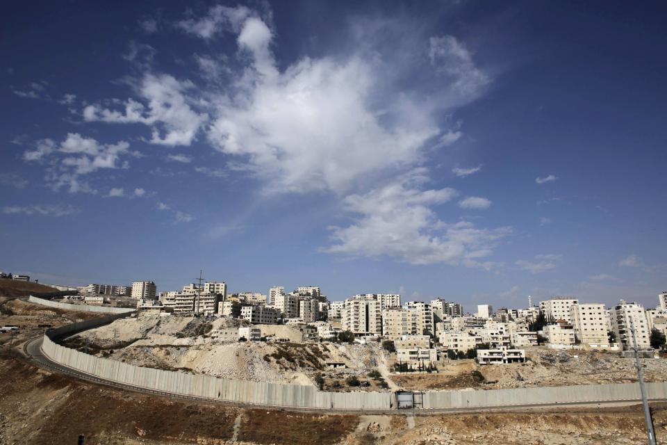 A section of the controversial Israeli barrier runs along the Shuafat refugee camp in the West Bank, as seen from Jerusalem